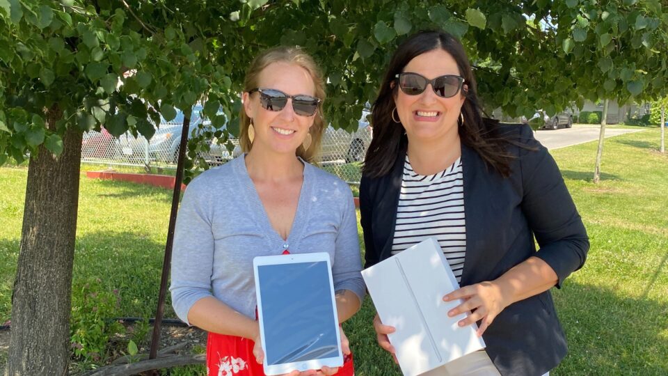 CWE CEO Joanne Soave presents iPads to ProsperUs as part of a donation.