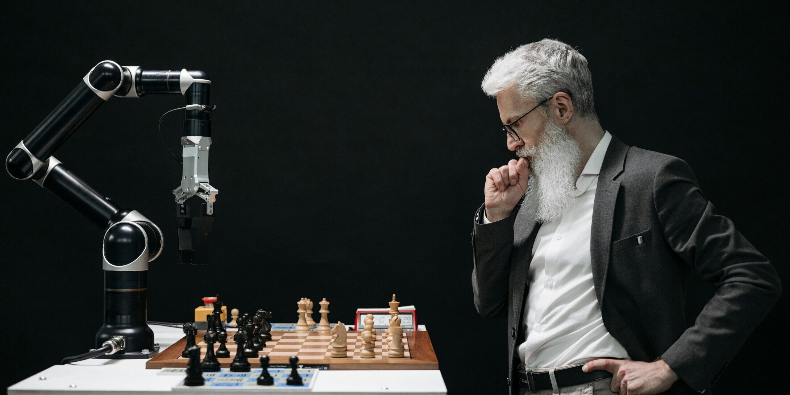 Chess with AI A man faces off against a robot in a game of chess, symbolizing the puzzle of understanding AI tools.