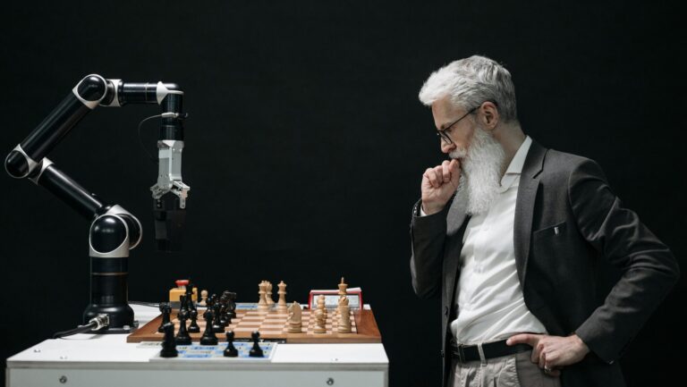 A man faces off against a robot in a game of chess, symbolizing the puzzle of understanding AI tools.