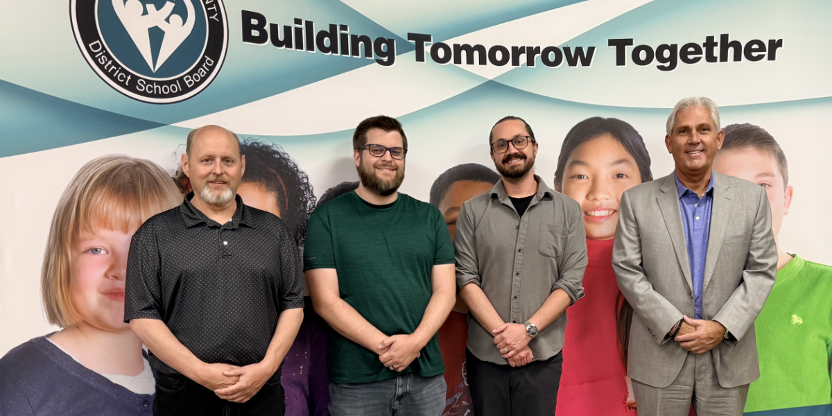 GECDSB team in front of banner