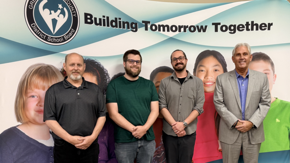 GECDSB team in front of banner