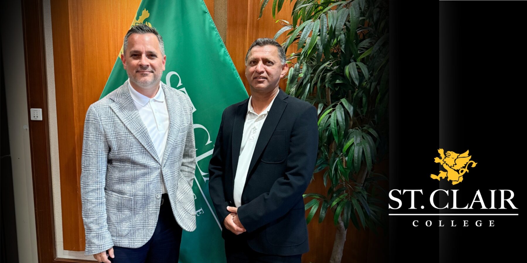two men in front of flag in board room