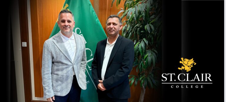 two men in front of flag in board room